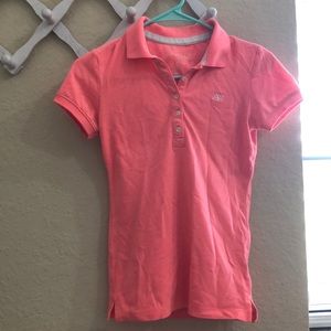 A coral pink collared shirt 🎟